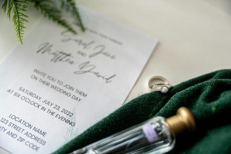 Close-up of a wedding vow book, pen and ribbon, symbolizing an engaged couple planning their wedding budget and financial wellness