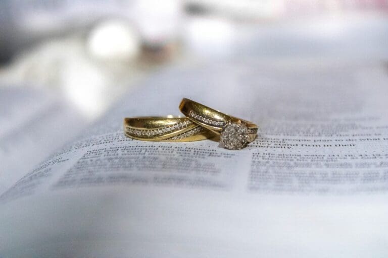 Gold wedding rings resting on a printed document, symbolizing insuring your ring and financial protection.