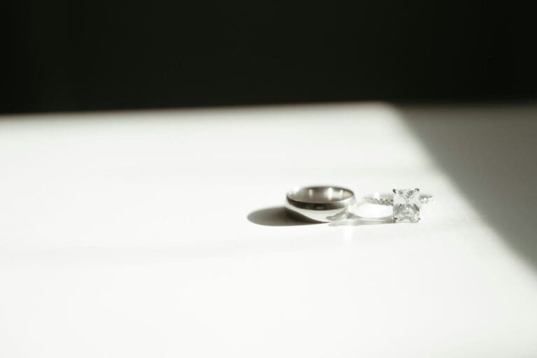 Men's wedding rings sitting on a table, symbolizing ring selection for him