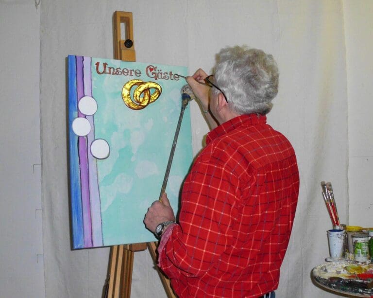 Painter working on a wedding live-painting scene